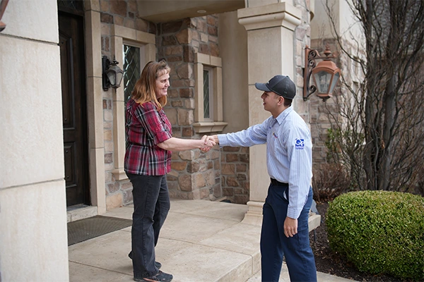 Guardian Pest Control Technician Greeting Customer at Utah Home