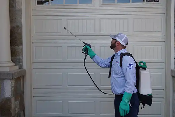 Licensed Guardian Pest Control technician providing family- and pet-conscious pest treatment at a Utah home.